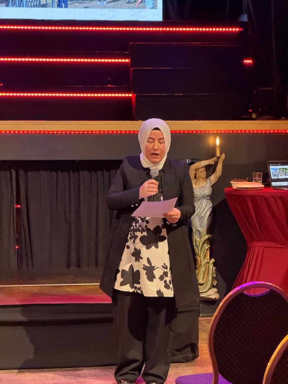 Een spreker deelt haar verhaal met de zaal